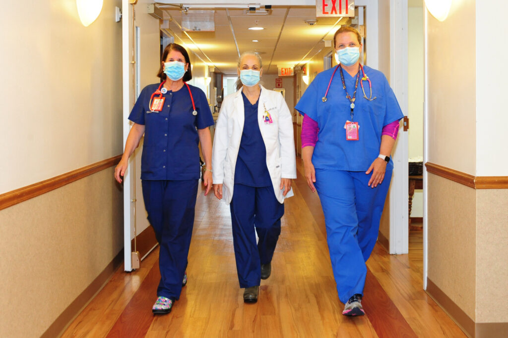 Healthcare workers walk down the hall at Fairview Hospital in Great Barrington